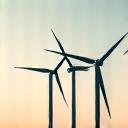 Illustration of modern, large-scale wind turbines against a clear sky